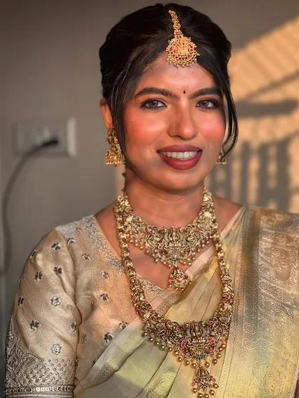 Golden hour perfection. The warm light enhances the golden tones of her saree and jewellery.
