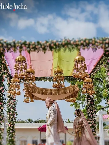 A stunning mandap setup with floral pillars and hanging kaleeras, another one of my shots featured by Incredible India.