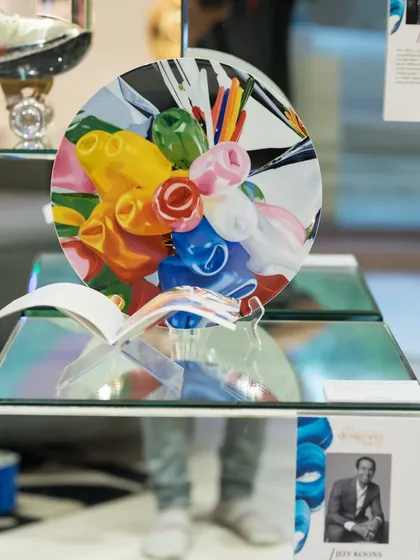 The 'Tulips Coupe Plate' (2014) by Jeff Koons. Known for transforming everyday objects into high-value art, Koons explores themes of commerce and consumerism in this iconic piece.