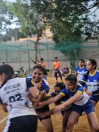 A powerful tackle in progress during a girls' Kabaddi practice match. This shows the grit and teamwork we develop.