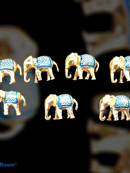 A set of designer buttons shaped like elephants with blue enamel detailing. These unique, gold-tone buttons are perfect for adding a touch of royal Indian heritage to a bandhgala or sherwani.