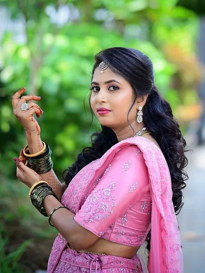 A classic portrait pose, showcasing the elegant makeup and hairstyle.