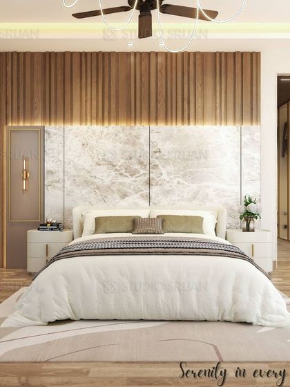This bedroom design is all about serenity, with a headboard that combines a lower marble section with upper wooden fluting. The backlighting creates a soft, ambient glow.
