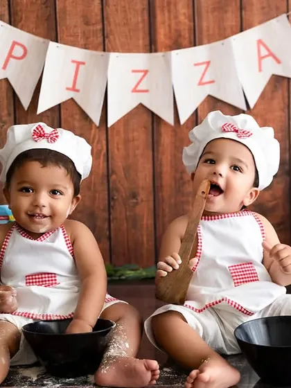 A fun and creative 'Little Chefs' themed photoshoot for twin babies. I offer unique themed sessions in my studio to celebrate milestones with playful and memorable setups.