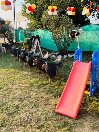 My kids' corner is set up with saddles for practice and a slide for fun, ensuring there's always something to do.