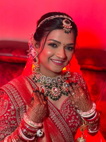 A happy and confident bride, looking straight at the camera, ready for her wedding ceremony.
