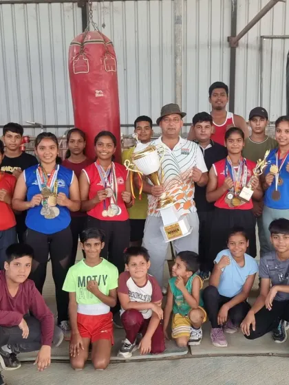 This is my team of champions. I am proud to stand with my students, both boys and girls, as they display the medals and trophies they have won through sheer dedication and hard work.