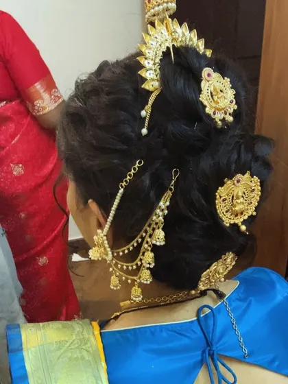 A traditional Marathi 'Khopa' bun, intricately decorated with multiple gold hair ornaments for a regal bridal look.
