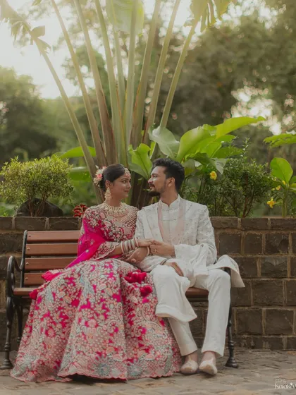 A quiet moment of connection, with the couple sitting on a bench and looking at each other. A simple, yet powerful portrait.