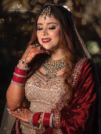 A happy and radiant bridal portrait, capturing the bride's beautiful smile and the intricate details of her wedding day look.