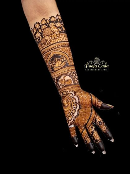 A single arm view of a beautiful bridal design, showcasing a portrait of the bride in a medallion on the palm, with traditional motifs extending up the arm.