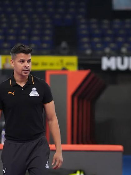 A moment of observation from the sidelines during a training session in the Mumbai arena.