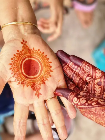 I love showing the two key stages of a natural henna stain. On the left is the fresh, bright orange color you see right after removing the paste, and on the right is the gorgeous deep stain from my own hand, developed after 48 hours.