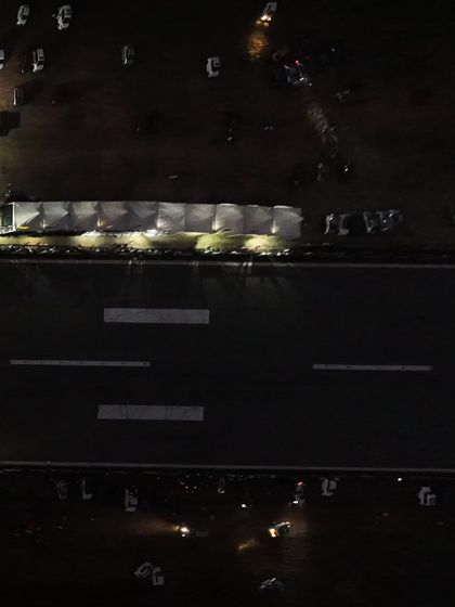 The Vroom Drag Meet by night. This aerial shot captures the sprawling venue illuminated after dark, showcasing the scale of our festival that runs from dawn till dusk.