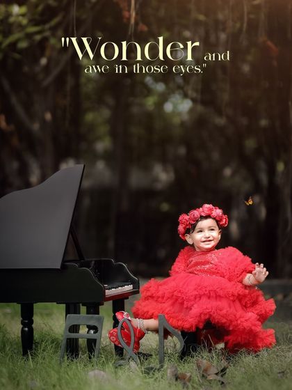 Wonder and awe in those eyes. A girl in a stunning red dress is visited by a butterfly as she plays the piano outdoors.