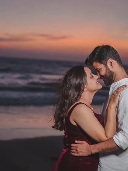 A close-up shot capturing the affection and connection between the couple, with the warm hues of the sunset creating a romantic mood.