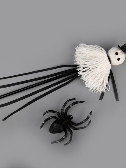 The ghost wand styled with a toy spider.