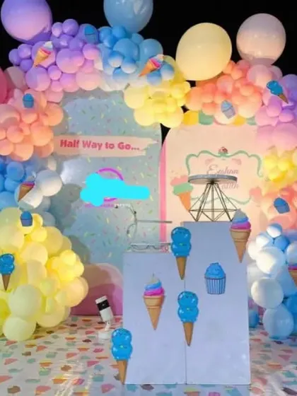 An ice cream themed party with large props and a pastel balloon arch.