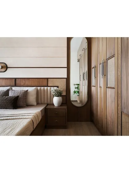 A full view of the parent's bedroom, showing the custom wardrobe with an integrated full-length mirror.