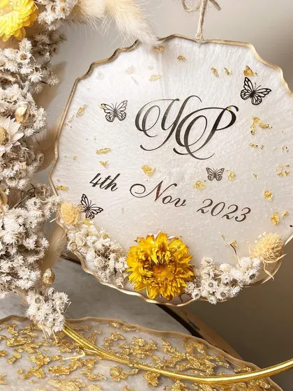 The personalized hanging sign with the couple's monogram and engagement date.