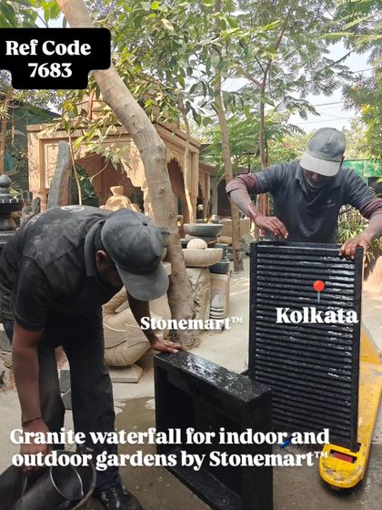 My team tests the water flow on a granite waterfall designed for both indoor and outdoor gardens.