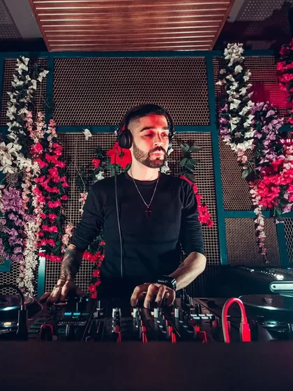 This is me in my element, focused on the mix at a private event. I use top-of-the-line Pioneer DJ equipment to ensure the sound is perfect and the transitions are seamless, creating a non-stop musical journey for my clients.