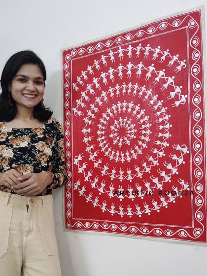 Here I am with a finished spiral dance Warli painting on canvas. This is one of the most popular and meditative compositions you will learn to master.