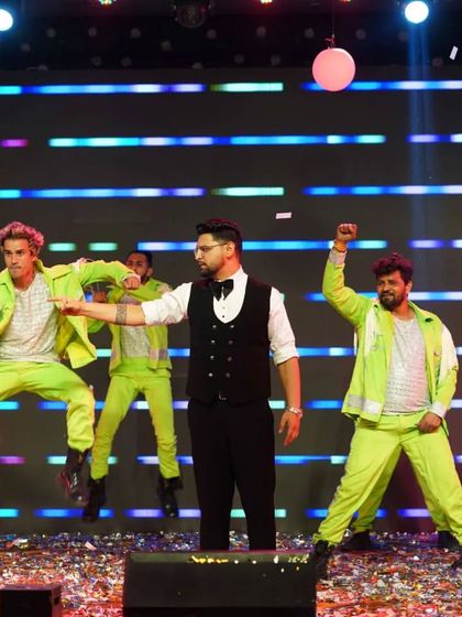 The synchronized jump shot. This shows the coordination and energy we bring to our performances with backup dancers, making the whole act look polished and professional.