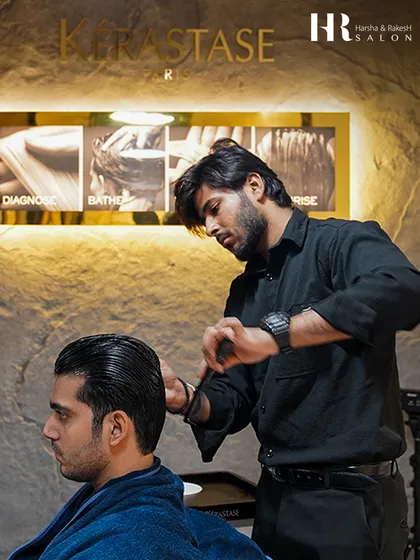 It's all in the details. Here, one of our expert stylists focuses on creating clean lines and perfect texture for a classic men's haircut, using premium Kérastase products for a flawless finish.
