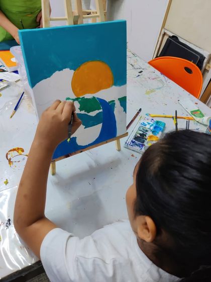 Scenes from our kids' acrylic workshop, where students learn to create bold and colorful landscape paintings.