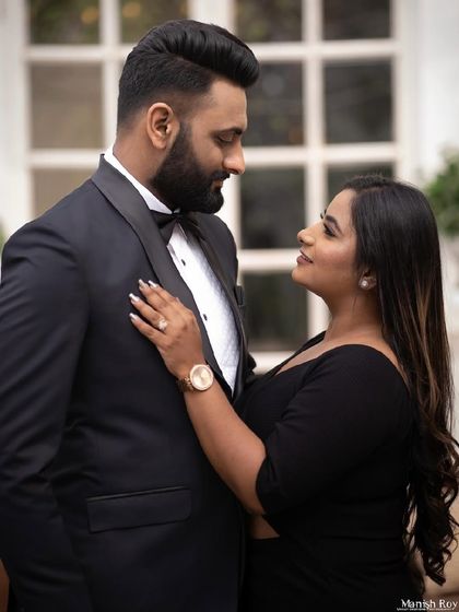A romantic shot of the couple in formal wear. Her makeup is elegant and classic, complementing the timeless black-tie theme.