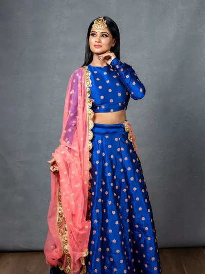 A full-length profile view, showing the beautiful drape of the lehenga and dupatta that I styled for this shoot.
