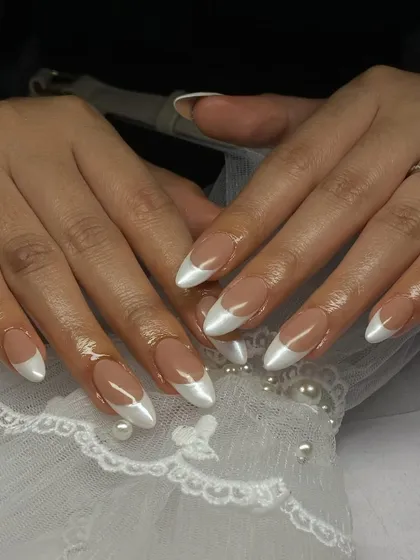 These almond-shaped nails feature a pearlescent white French tip, giving a classic style a modern, shimmery twist.