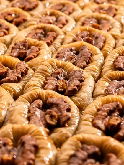 A sea of walnut baklava, showing the texture of the nuts and the perfectly baked pastry. This kind of shot is great for showing abundance and quality.