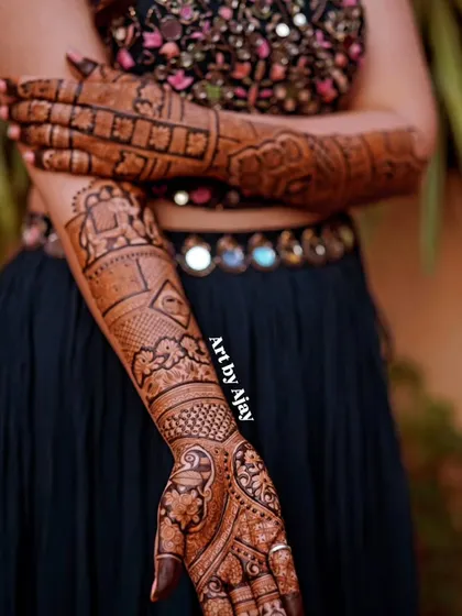 A close-up of a bridal arm design featuring an elephant motif inside a decorative frame, showcasing traditional Rajasthani art.