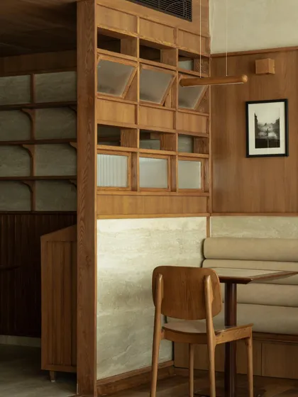 A wooden partition with fluted glass, providing privacy while allowing light to filter through.