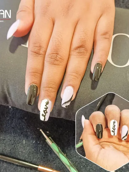 Your nails can speak your style. For this client, I did a modern black and white design with hand-painted script that says "love" on an accent nail. It's a chic and personal statement.