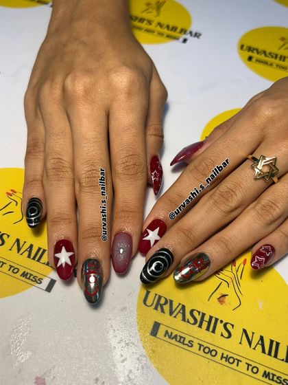 A retro and fun set inspired by Coca-Cola. I combined the iconic logo on a chrome nail with bold red, stars, and graphic black and white swirls for a pop-art vibe.