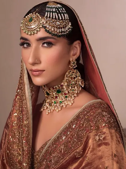 A full portrait of the bride with the passa, showing how the makeup and jewellery come together to create a look of timeless elegance.