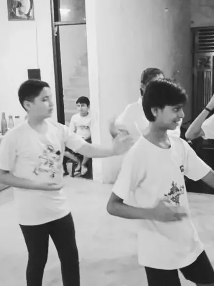 The class is practicing a sequence of blocks. This drill helps in memorizing the movements and making them instinctive.