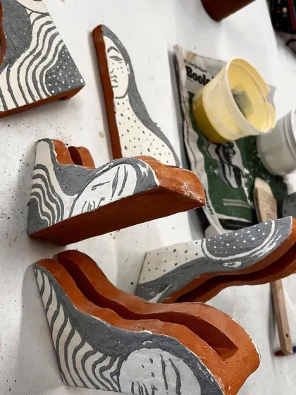The ceramic pieces for 'Confrontation' after being glazed and fired, laid out before assembly.