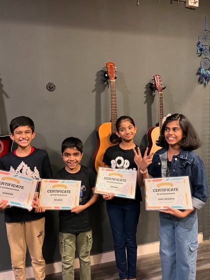 A group of our talented young prize-winners proudly holding their certificates. We encourage creativity and celebrate the achievements of all our students.