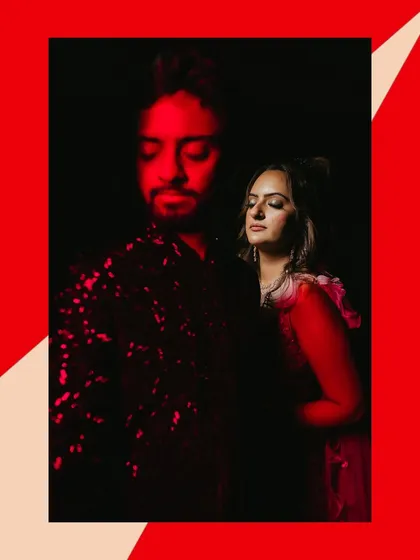 A creative couple portrait using bold red lighting to create a dramatic and passionate mood for their Sangeet shoot.