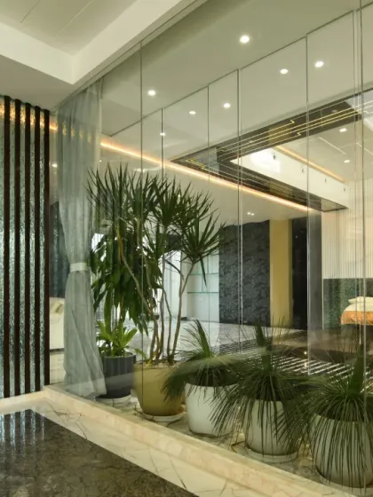 Additional views showcasing the interplay of glass walls, marble floors, and wooden slat details. These images highlight how we use materials to define spaces and create visual continuity.