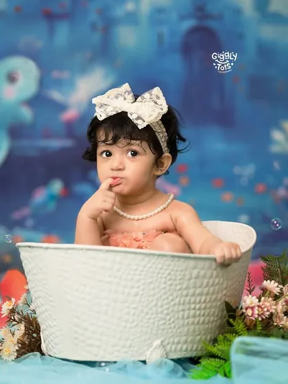 Splish, splash, it's mermaid magic in the bath! A curious little mermaid peeks out of her tub in our whimsical underwater world.