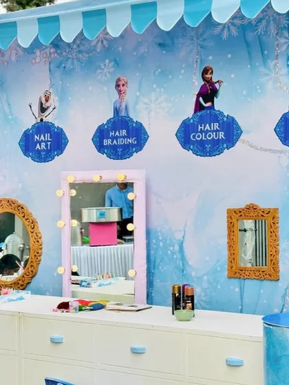 The fun extends beyond the backdrop. For this Frozen party, I set up a themed activity station for kids, offering tattoos, nail art, hair braiding, and face stickers to keep them entertained.