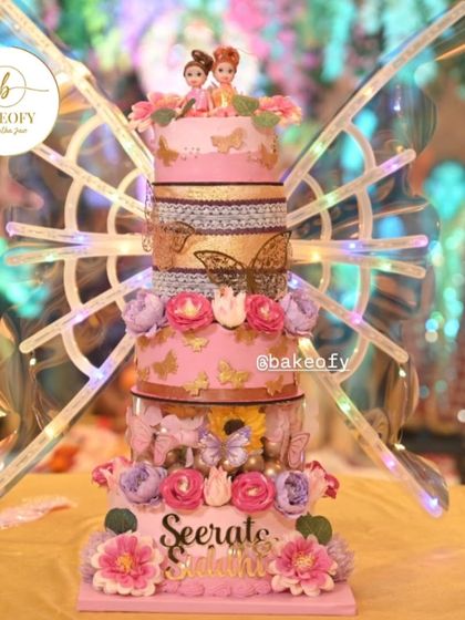 A stunning 5-tier cake for a twin's birthday, combining a floral theme with enchanting butterfly kinetic wings. This is how you create a showstopper that leaves everyone in awe.