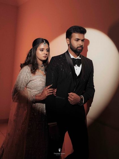 A stylish, cinematic portrait of the couple at their reception, using a spotlight to create a dramatic and modern effect.