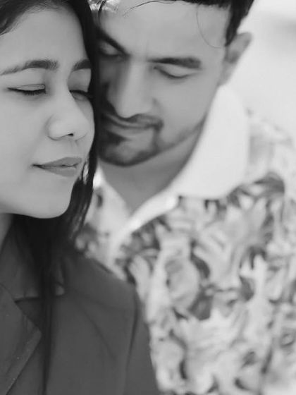 A beautiful and serene black and white portrait. The soft focus and the couple's peaceful expressions create a timeless and emotional image.