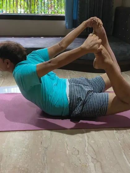 Age is just a number when it comes to yoga. This client is demonstrating a deep Dhanurasana, or Bow Pose, which is excellent for strengthening the back and improving posture. My personalized guidance ensures that even advanced poses are approached safely.